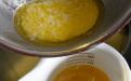 The leftover solids from making ghee, with a cup of ghee below.